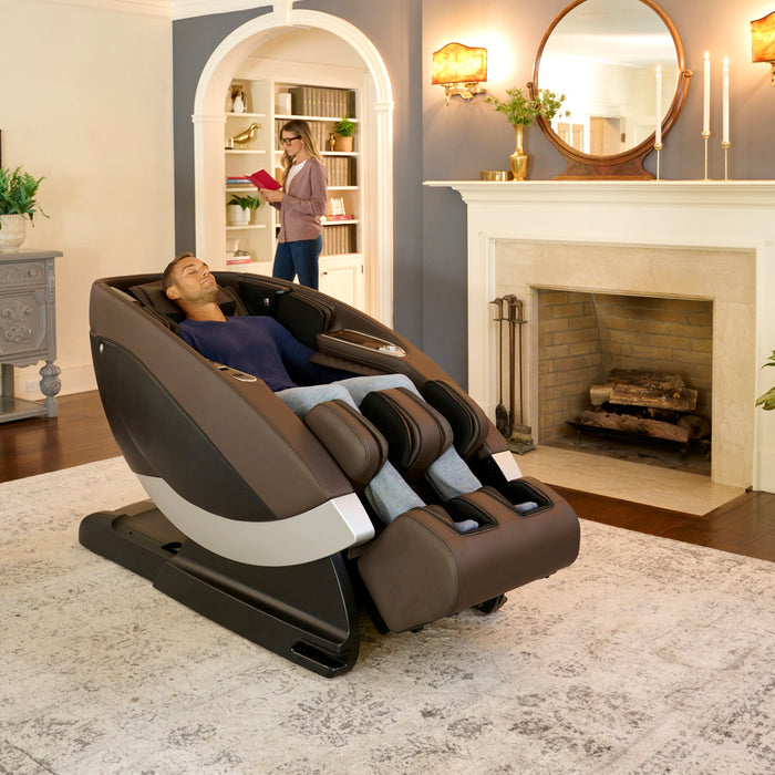 Man sitting in the Super Novo Massage Chair by Human Touch in a living room setting