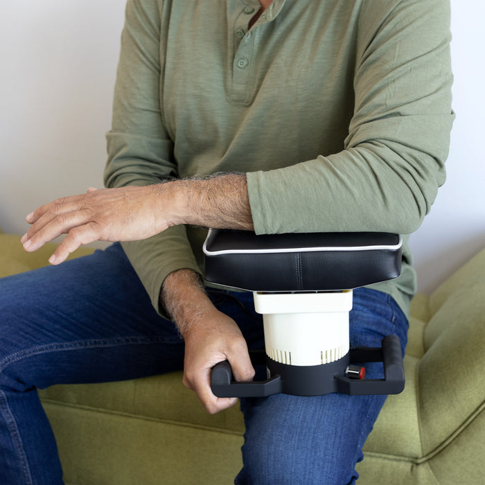 A man using the Oscillatory Body Massager on his arm.