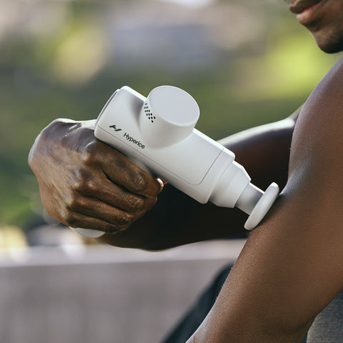 A man using the Hypervolt Go on his arm.